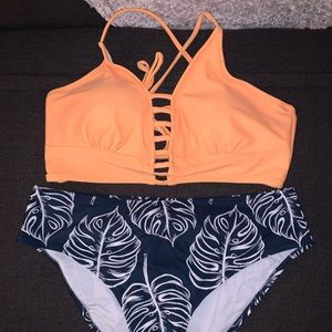 Yellow and navy floral bikini. Crisscross tie top with bottoms. Never worn.